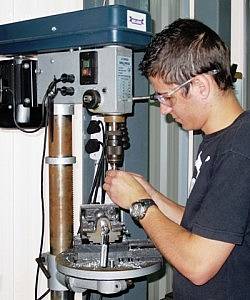 Sidney Koen operating the drill press